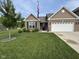 Well-maintained, single-story home with a lush front yard, brick facade, and attached two car garage at 1684 Hedley W Way, Avon, IN 46123
