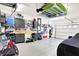 Well-organized garage with overhead storage, work bench, and epoxy flooring at 1684 Hedley W Way, Avon, IN 46123