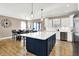 Spacious kitchen with an island, dining table, and stainless steel appliances offers ample space at 1684 Hedley W Way, Avon, IN 46123