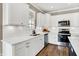 Modern kitchen with white cabinets, quartz countertops, stainless steel appliances, and hardwood flooring at 1684 Hedley W Way, Avon, IN 46123