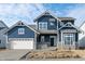 Charming two-story home featuring a blue facade, white trim, stone accents, and an attached two-car garage at 19854 Chatham Shore Ln, Westfield, IN 46074