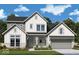 Charming two-story home with a covered entryway, complemented by stone accents and a neatly manicured front lawn at 19854 Chatham Shore Ln, Westfield, IN 46074
