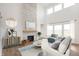 Cozy living room with a stone fireplace, comfortable seating, and lots of natural light at 19854 Chatham Shore Ln, Westfield, IN 46074