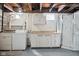 The basement features a laundry area, built-in cabinets, and a shower at 2022 Newton St, Columbus, IN 47201