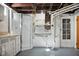 Basement featuring a shower, sink, cabinets, mirror and an exterior door at 2022 Newton St, Columbus, IN 47201