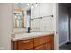 Bathroom featuring a modern vanity, faucet, and fixtures with a decorative mirror at 2022 Newton St, Columbus, IN 47201