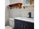 Bathroom vanity with dark blue cabinets, white countertop and backsplash, and black faucet at 2022 Newton St, Columbus, IN 47201