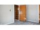 Bedroom featuring carpet flooring, neutral paint, door, and closet at 2022 Newton St, Columbus, IN 47201