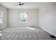 Spacious bedroom featuring plush gray carpeting, neutral paint, and a ceiling fan at 2022 Newton St, Columbus, IN 47201