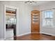 Dining room featuring hardwood floors, corner cabinet, natural light, and an open doorway to the kitchen at 2022 Newton St, Columbus, IN 47201