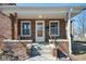 Close-up of the home's covered front porch, showcasing the brickwork and entry door at 2022 Newton St, Columbus, IN 47201