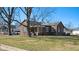Attractive brick home with a covered porch and mature trees in a residential neighborhood at 2022 Newton St, Columbus, IN 47201