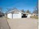 Detached white garage featuring a modern door and a driveway at 2022 Newton St, Columbus, IN 47201