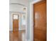Living room with hardwood floors, a decorative ceiling, wooden doors and trim, and a neutral color palette at 2022 Newton St, Columbus, IN 47201