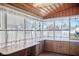 Bright sunroom filled with natural light from large windows and finished with built-in cabinets at 2022 Newton St, Columbus, IN 47201