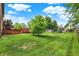 Large backyard showcasing a spacious lawn with a wooden deck and play set, ideal for Gathering fun at 211 Deborah Ln, Whiteland, IN 46184