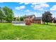 Expansive backyard featuring a well-maintained lawn and an above-ground pool with a deck, perfect for outdoor entertainment at 211 Deborah Ln, Whiteland, IN 46184