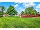 Spacious backyard featuring a well-maintained lawn, storage shed, and large deck, great for outdoor activities at 211 Deborah Ln, Whiteland, IN 46184