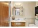Neutral bathroom featuring a wood vanity, mirrored medicine cabinet, and a toilet with safety bars at 211 Deborah Ln, Whiteland, IN 46184