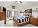 Bedroom with a large window, and ceiling fan complemented by warm-toned wooden furniture at 211 Deborah Ln, Whiteland, IN 46184