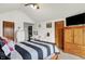 Bright bedroom featuring a bed, a TV and wooden furniture providing ample storage space at 211 Deborah Ln, Whiteland, IN 46184