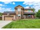 Charming two-story home featuring a well-manicured lawn, a covered porch with an American flag, and an attached two-car garage at 211 Deborah Ln, Whiteland, IN 46184