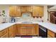 Traditional kitchen with light wood cabinetry, white countertops and stainless steel sink basin at 211 Deborah Ln, Whiteland, IN 46184