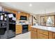 Bright kitchen featuring wooden cabinets, white counters, black appliances, and an eat-in area at 211 Deborah Ln, Whiteland, IN 46184