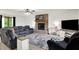 Cozy living room featuring a brick fireplace, a large gray sectional sofa, and a plush gray rug at 211 Deborah Ln, Whiteland, IN 46184