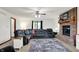 Spacious living room featuring a brick fireplace, a large gray sectional, and a walkout to the front yard at 211 Deborah Ln, Whiteland, IN 46184