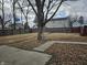 Picturesque backyard view with mature trees and landscaping, perfect for enjoying the outdoors at 2113 Silver St, Anderson, IN 46012