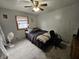 Comfortable bedroom with a ceiling fan and wood-trim window offering natural light at 2113 Silver St, Anderson, IN 46012