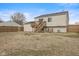 View of the backyard with a wooden deck, and stairs leading down to the yard at 2323 Chaucer Dr, Columbus, IN 47201