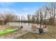 Backyard featuring a serene pond, dock access, and cozy firepit area with chairs, ideal for outdoor enjoyment at 2323 Chaucer Dr, Columbus, IN 47201