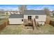 Backyard view featuring a wooden deck, with stairs and well-maintained yard at 2323 Chaucer Dr, Columbus, IN 47201