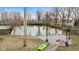 Scenic backyard view with pond, dock, kayak, and firepit seating area, creating a relaxing outdoor oasis at 2323 Chaucer Dr, Columbus, IN 47201