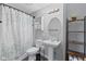 Bathroom featuring a pedestal sink, white toilet, and decorative shower curtain at 2323 Chaucer Dr, Columbus, IN 47201