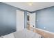 Bedroom features an open doorway to a bathroom and laminate flooring at 2323 Chaucer Dr, Columbus, IN 47201