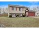 Charming home featuring red shutters, a red garage door, and a well-maintained front lawn at 2323 Chaucer Dr, Columbus, IN 47201