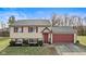 Charming home featuring red shutters, a red garage door, and a well-maintained front lawn at 2323 Chaucer Dr, Columbus, IN 47201