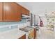 Bright kitchen featuring a subway tile backsplash, range, wood cabinets, and stainless steel appliances at 2323 Chaucer Dr, Columbus, IN 47201