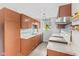 Galley kitchen features stainless steel appliances, wood cabinetry, and updated countertops at 2323 Chaucer Dr, Columbus, IN 47201