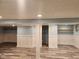 Spacious finished basement featuring modern flooring, wainscoting, and support beams at 2441 Northview Ave, Indianapolis, IN 46220