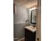Modern bathroom featuring a vanity with a white sink and storage, complemented by stylish lighting at 2441 Northview Ave, Indianapolis, IN 46220