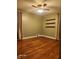 Bedroom featuring wood floors, neutral walls, three shelves, and ample space at 2441 Northview Ave, Indianapolis, IN 46220