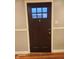A dark wood front door with a window and trim at 2441 Northview Ave, Indianapolis, IN 46220