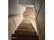 View of wood stairs leading to the upper level with white railing and accent wall at 2441 Northview Ave, Indianapolis, IN 46220