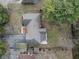 Birds eye view of home featuring mature trees, driveway, brick patio and fenced yard at 252 N Raceway Rd, Indianapolis, IN 46234