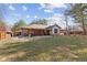 Spacious brick home with a covered patio and large grassy backyard, perfect for outdoor living and entertaining at 252 N Raceway Rd, Indianapolis, IN 46234