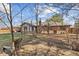 A cozy backyard featuring a brick home exterior, a chimney, and mature trees providing shade and privacy at 252 N Raceway Rd, Indianapolis, IN 46234